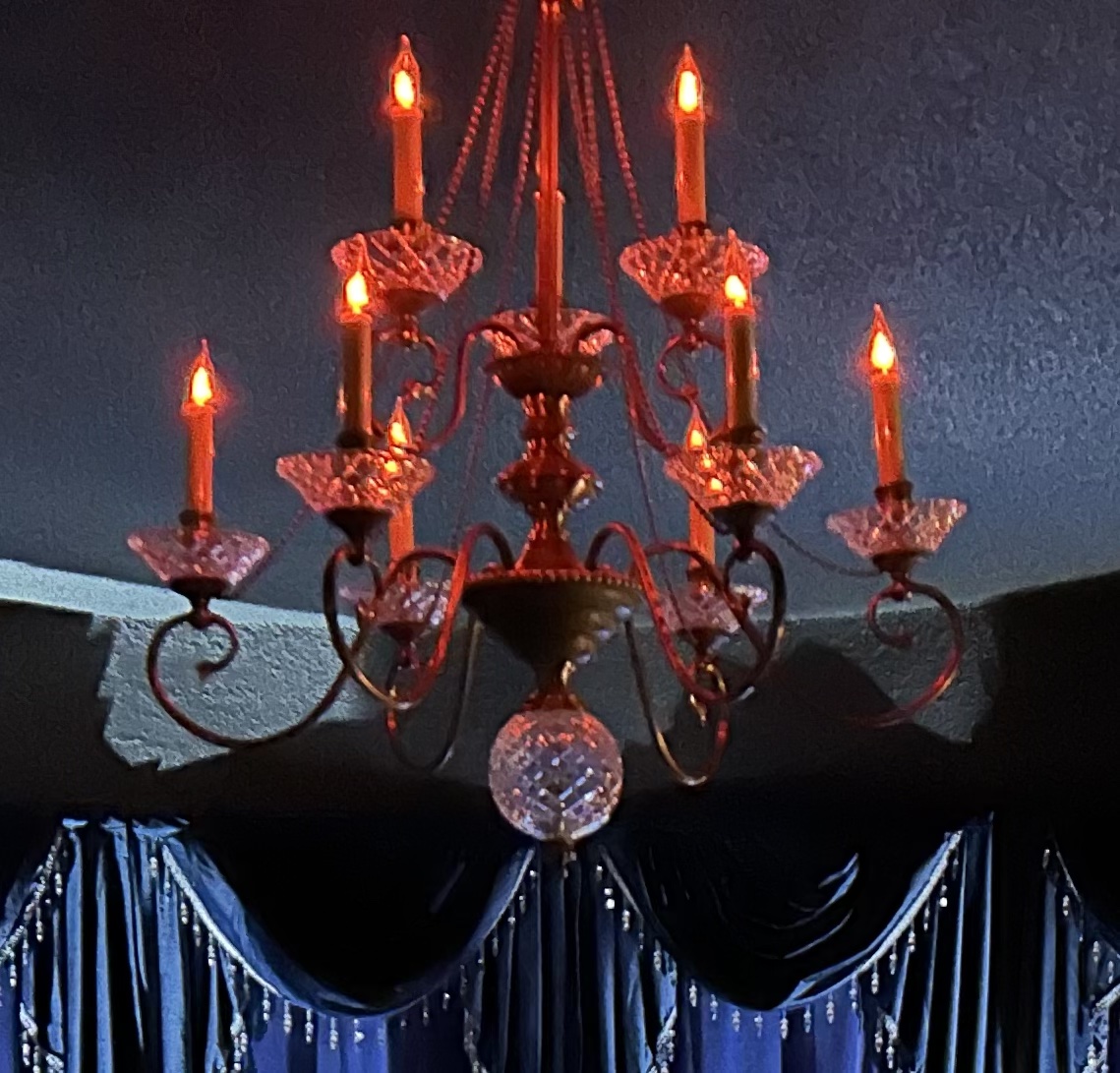 Elegant chandelier with glowing candle lights.